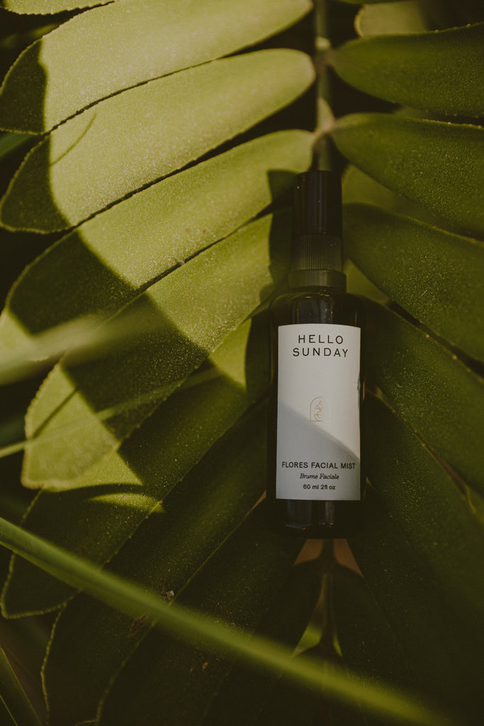 Hello Sunday Flores Facial Mist layed down in leaves